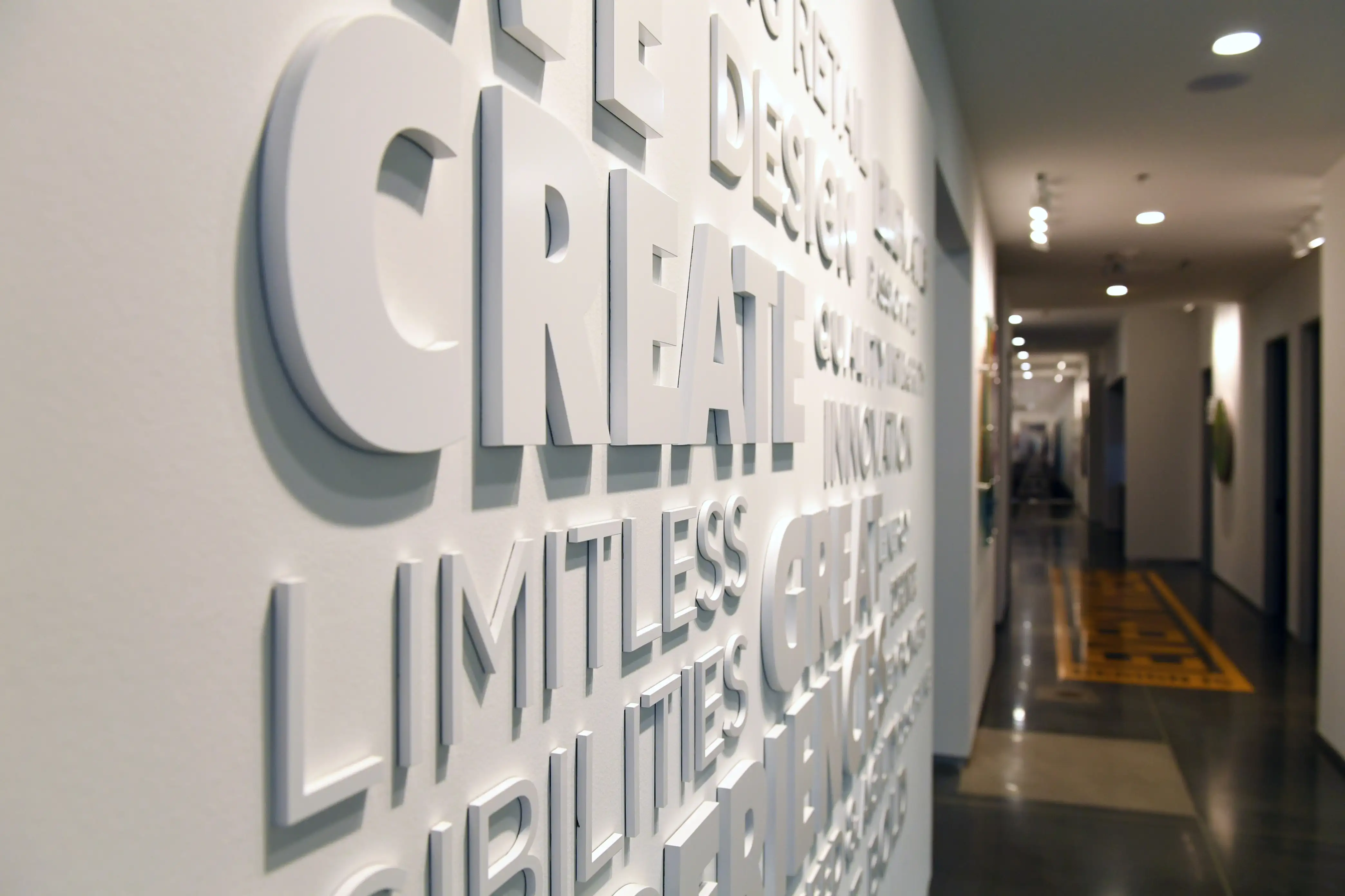 Foxmark craftsmen workshop interior with 'We Are Artists At Our Craft' brand manifesto signage